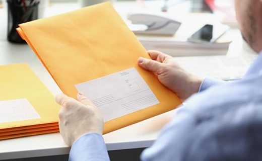 Man hold envelope, prepare package to give to courier for further delivery